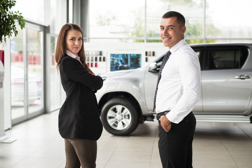 young man woman dealership